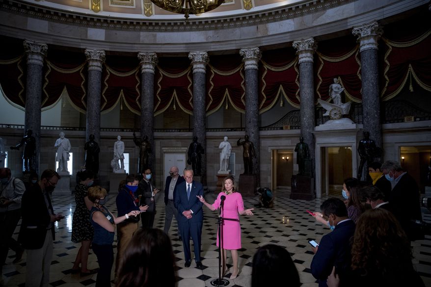 FILE - In this Aug. 7, 2020, file photo House Speaker Nancy Pelosi of Calif., center, accompanied by Senate Minority Leader Sen. Chuck Schumer of N.Y., left, speaks to members of the media after meeting with Treasury Secretary Steven Mnuchin and White House Chief of Staff Mark Meadows as they continue to negotiate a coronavirus relief package on Capitol Hill in Washington. The battle for control of Congress this fall is solidifying into a race about President Donald Trump. (AP Photo/Andrew Harnik, File)