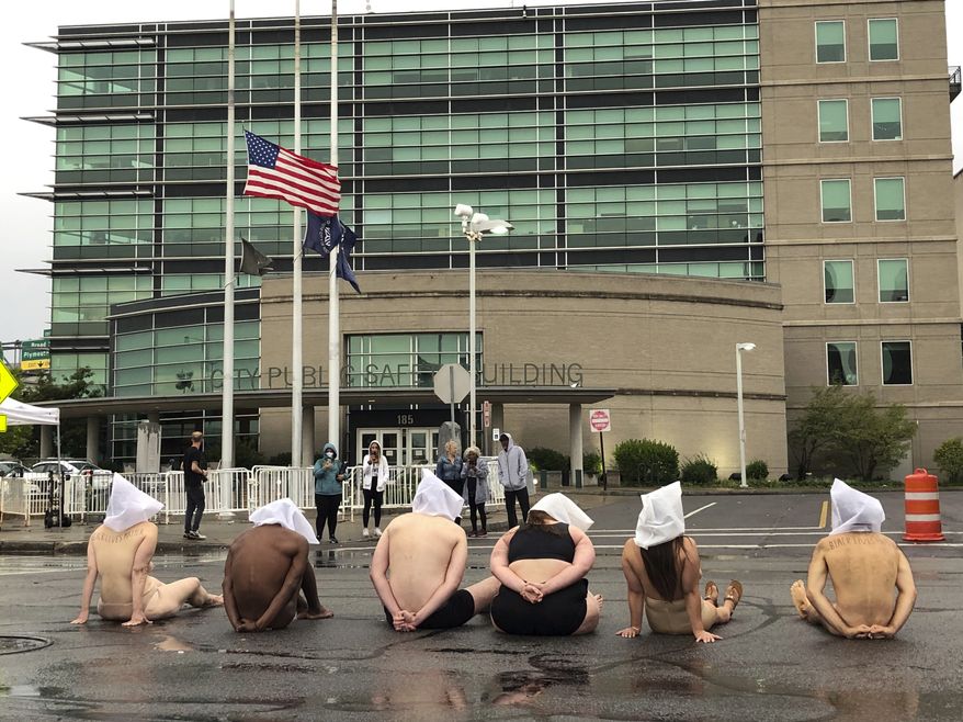 Naked protesters, wearing &quot;spit hoods&quot; in reference to the killing of Daniel Prude, demonstrate outside Rochester&#39;s Public Safety Building in Rochester, N.Y., Monday, Sept. 7, 2020. (Tracy Schuhmacher/Democrat &amp; Chronicle via AP)