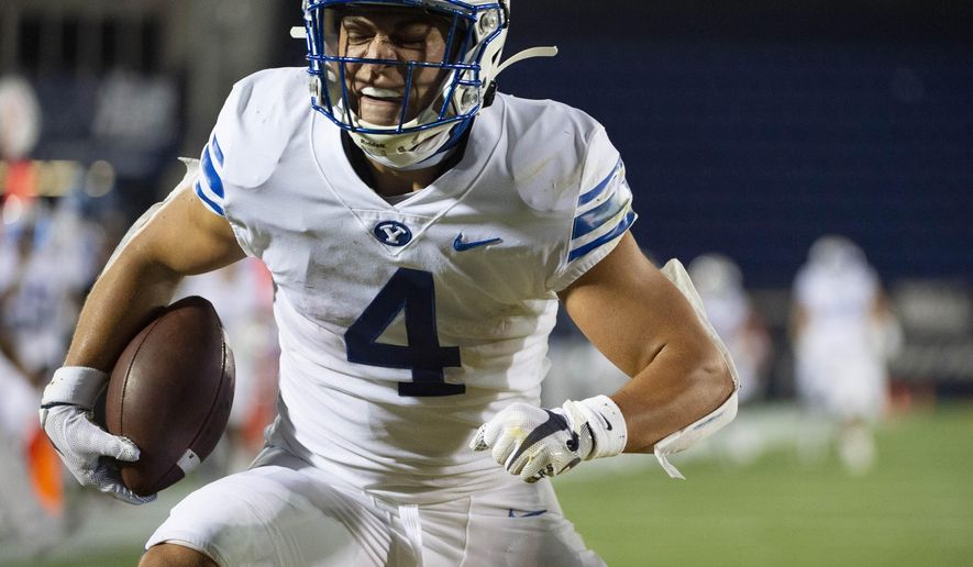 BYU's Lopini Katoa (4) reacts after scoring a touchdown during the first half of an NCAA college football game against Navy, Monday, Sept. 7, 2020, in Annapolis, Md. (AP Photo/Tommy Gilligan)