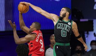 Boston Celtics&#39; Jayson Tatum (0) blocks the shot of Toronto Raptors&#39; Serge Ibaka (9) during the second half of an NBA conference semifinal playoff basketball game Monday, Sept. 7, 2020, in Lake Buena Vista, Fla. (AP Photo/Mark J. Terrill)