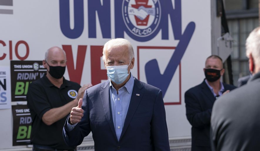 Democratic presidential candidate former Vice President Joe Biden gives the thumbs up as he arrives to pose for photographs with union leaders outside the AFL-CIO headquarters in Harrisburg, Pa., Monday, Sept. 7, 2020. (AP Photo/Carolyn Kaster)
