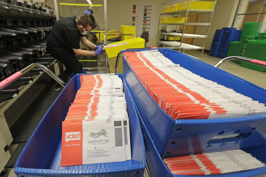 FILE - In this Aug. 5, 2020, file photo, vote-by-mail ballots are shown in sorting trays at the King County Elections headquarters in Renton, Wash., south of Seattle. In every U.S. presidential election, thousands of ballots are rejected and never counted. They may have arrived after Election Day or were missing a voter's signature. That number will be far higher this year as the coronavirus pandemic forces tens of millions of Americans to vote by mail for the first time. (AP Photo/Ted S. Warren, File)