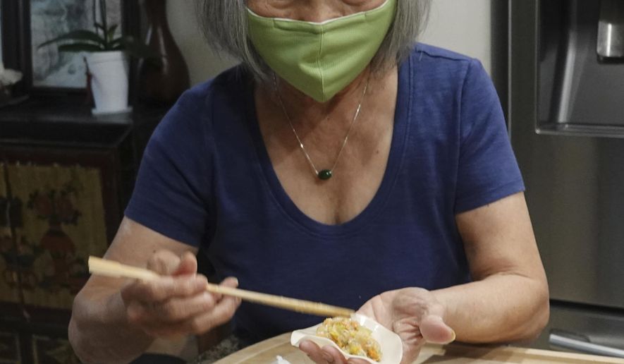 Shirley Shea makes dumplings at her home in Fort Lauderdale, Fla., Wednesday, Aug. 19, 2020. The tapestry of pork dumplings on Calvin Shea’s Instagram feed has been popular in quarantine during the coronavirus pandemic. But not nearly as popular as his 80-year-old mom, Shirley. What started as a way to renew their relationship after living apart for decades has turned, practically overnight, into an all-consuming dumpling business. (Joe Cavaretta/South Florida Sun-Sentinel via AP)