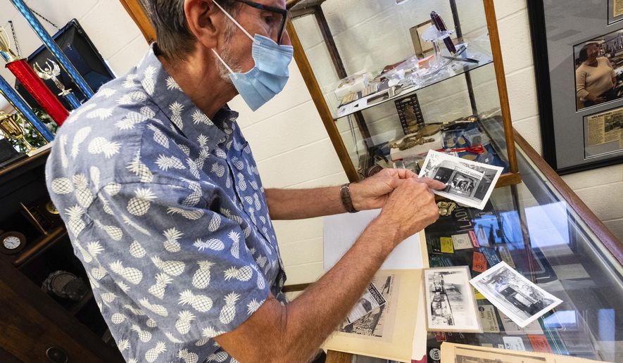 Mark Prochazka, who took over Schwem&#39;s Rubber Stamp &amp;amp; Trophy from his grandfather about 42 years ago, talks about old photos of the original store Tuesday, Aug. 25, 2020, in Port Huron, Mich. In January, Prochazka passed the store down to his son-in-law Russell Corbat. (Brian Wells/The Times Herald via AP)