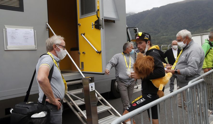 Slovenia's Primoz Roglic waits outside the doping control facility after the ninth stage of the Tour de France cycling race over 153 kilometers (95 miles), with start in Pau and finish in Laruns, Sunday, Sept. 6, 2020. (AP Photo/Christophe Ena)