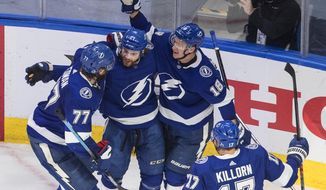 Tampa Bay Lightning&#39;s Victor Hedman (77), Brayden Point (21), Ondrej Palat (18) and Alex Killorn (17) celebrate a goal during second-period NHL Eastern Conference final playoff game action against the New York Islanders in Edmonton, Alberta, Monday, Sept. 7, 2020. (Jason Franson/The Canadian Press via AP)