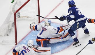 Tampa Bay Lightning&#39;s Brayden Point (21) scores on New York Islanders goalie Thomas Greiss (1) during the first period of an NHL Eastern Conference final playoff game, Monday, Sept. 7, 2020, in Edmonton, Alberta. (Jason Franson/The Canadian Press via AP)