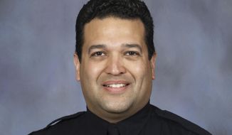 FILE - This photo provided by the Lincoln, Neb., police department, shows Lincoln police officer Luis &amp;quot;Mario&amp;quot; Herrera. Authorities said Herrera, who was shot while attempting to arrest a 17-year-old on an assault charge, died Monday, Sept. 7, 2020, after a nearly two-week battle to save his life.  (Lincoln Police Department via AP, File)