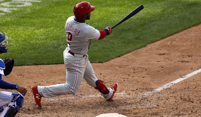 Philadelphia Phillies&#x27; Jean Segura hits a two-run home run during the 10th inning of a baseball game against the New York Mets on Monday, Sept. 7, 2020, in New York. (AP Photo/Adam Hunger)