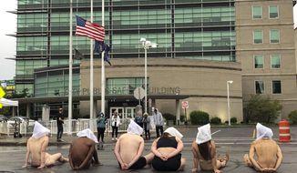 Naked protesters, wearing &amp;quot;spit hoods&amp;quot; in reference to the killing of Daniel Prude, demonstrate outside Rochester&#x27;s Public Safety Building in Rochester, N.Y., Monday, Sept. 7, 2020. (Tracy Schuhmacher/Democrat &amp;amp; Chronicle via AP)