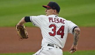 Cleveland Indians starting pitcher Zach Plesac delivers in the first inning of a baseball game against the Kansas City Royals, Monday, Sept. 7, 2020, in Cleveland. (AP Photo/Tony Dejak)