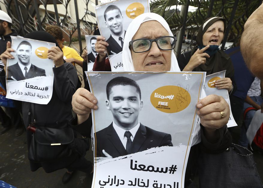 People gather in a show of support for Khaled Drareni,outside the court house Tuesday, Sept.8, 2020 in Algiers. Drareni was imprisoned Aug. 10 for "inciting an unarmed gathering" and "endangering national unity" linked to coverage of Algeria's Hirak protest movement. One month after journalist Khaled Drareni was sentenced to three years in prison in Algeria, a court in the North African country is hearing his appeal Tuesday. (AP Photo/Anis Belghoul)