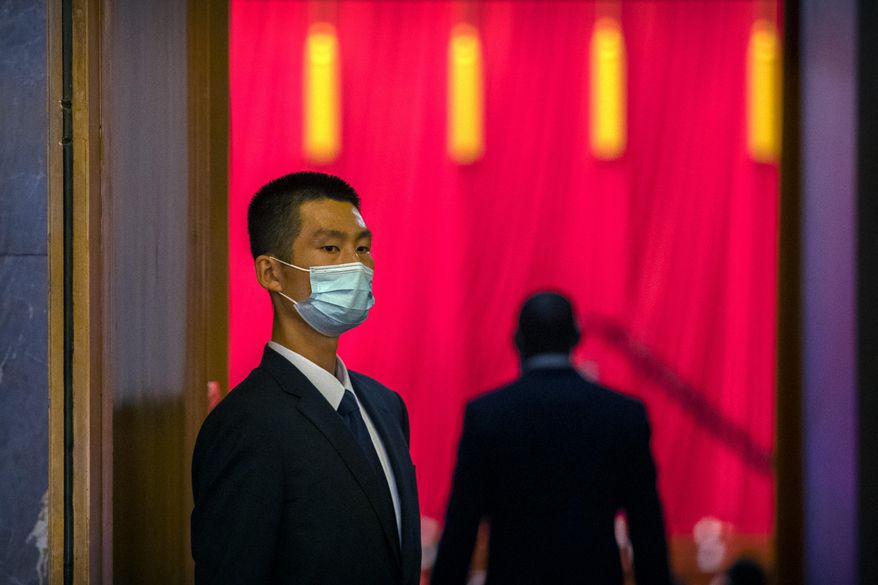 A security official wearing a face mask stands guard before an event to honor some of those involved in China&#39;s fight against COVID-19 at the Great Hall of the People in Beijing, Tuesday, Sept. 8, 2020. Chinese leader Xi Jinping is praising China&#39;s role in battling the global coronavirus pandemic and expressing support for the U.N.&#39;s World Health Organization, in a repudiation of U.S. criticism and a bid to rally domestic support for Communist Party leadership. (AP Photo/Mark Schiefelbein) **FILE**