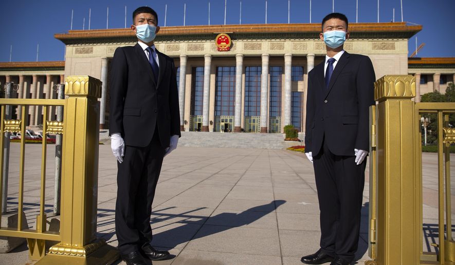 Security officials wearing face masks stand guard outside the Great Hall of the People before an event to honor some of those involved in China&#x27;s fight against COVID-19 in Beijing, Tuesday, Sept. 8, 2020. Chinese leader Xi Jinping is praising China&#x27;s role in battling the global coronavirus pandemic and expressing support for the U.N.&#x27;s World Health Organization, in a repudiation of U.S. criticism and a bid to rally domestic support for Communist Party leadership. (AP Photo/Mark Schiefelbein)