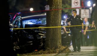 Police work the scene where an 8-year-old girl was killed and two adults were gunned down when someone shot into a car near the intersection of 47th street and Union Avenue during the Labor Day weekend Monday, Sept. 7, 2020, in Chicago. (Armando L. Sanchez/Chicago Tribune via AP)