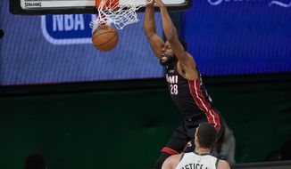 Miami Heat&#39;s Andre Iguodala (28) dunks in front of Milwaukee Bucks&#39; Brook Lopez (11) in the second half of an NBA conference semifinal playoff basketball game Tuesday, Sept. 8, 2020 in Lake Buena Vista, Fla. (AP Photo/Mark J. Terrill)