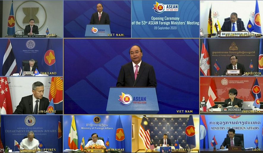 This image taken from video provided by VTV shows ASEAN foreign ministers watching Vietnamese Prime Minister Nguyen Xuan Phuc, center, delivering a speech during the opening of ASEAN Foreign Ministers&#39; Meeting on Wednesday, Sept. 9, 2020. Southeast Asia&#39;s top diplomats are holding their annual talks by video Wednesday to discuss the immense crisis wrought by the coronavirus pandemic and rising tensions in the South China Sea amid the escalating rivalry between Washington and Beijing. (VTV via AP)