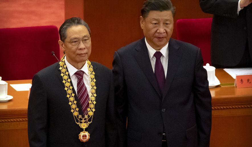 Chinese President Xi Jinping, right, stands with Chinese medical expert Zhong Nanshan after awarding him a medal at an event to honor some of those involved in China&#39;s fight against COVID-19 at the Great Hall of the People in Beijing, Tuesday, Sept. 8, 2020. Chinese leader Xi Jinping is praising China&#39;s role in battling the global coronavirus pandemic and expressing support for the U.N.&#39;s World Health Organization, in a repudiation of U.S. criticism and a bid to rally domestic support for Communist Party leadership. (AP Photo/Mark Schiefelbein)