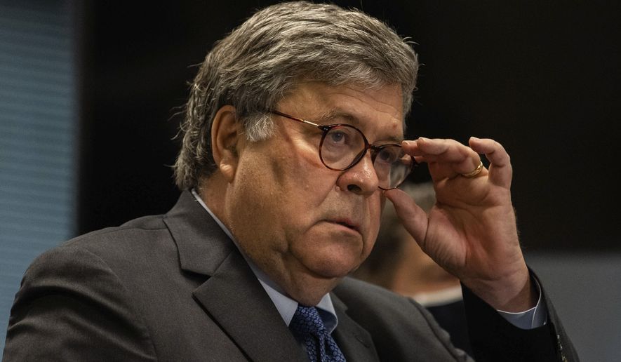 Attorney General William Barr adjusts his glasses during a press conference about Operation Legend at the Dirksen Federal Building, Wednesday morning, Sept. 9, 2020, in Chicago. Barr said the operation was &quot;critical in cutting Chicago&#39;s murder rate roughly in half since before the operation.&quot; (Pat Nabong/Chicago Sun-Times via AP)