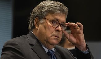 Attorney General William Barr adjusts his glasses during a press conference about Operation Legend at the Dirksen Federal Building, Wednesday morning, Sept. 9, 2020, in Chicago. Barr said the operation was &quot;critical in cutting Chicago&#x27;s murder rate roughly in half since before the operation.&quot; (Pat Nabong/Chicago Sun-Times via AP)