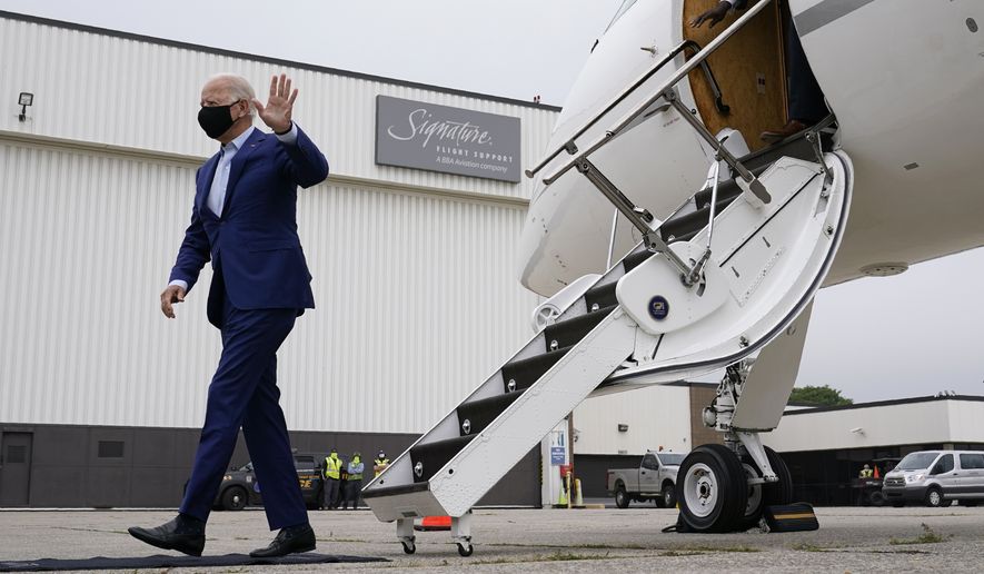 Democratic presidential candidate former Vice President Joe Biden waves as he steps off a plane at Detroit Metropolitan Wayne County Airport in Detroit, Wednesday, Sept. 9, 2020. Biden is attending campaign events in Michigan. (AP Photo/Patrick Semansky)