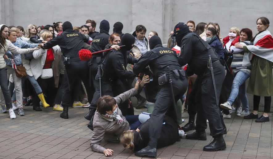 Police officers detain protesters during a rally in support of Maria Kolesnikova, a member of the Coordination Council created by the opposition to facilitate talks with Lukashenko on a transition of power, was detained Monday in the capital of Minsk with two other council members, in Minsk, Belarus, Tuesday, Sept. 8, 2020. A leading opposition activist in Belarus is being held on the border with Ukraine after she resisted attempts by authorities to deport her from the country as part of a clampdown on protests against authoritarian President Alexander Lukashenko. (AP Photo)