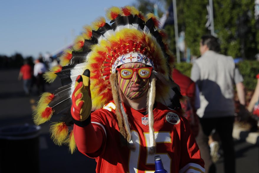 In this Feb. 2, 2020 file photo, a Kansas City Chiefs fan walks outside the stadium before the NFL Super Bowl 54 football game between the San Francisco 49ers and Kansas City Chiefs in Miami Gardens, Fla. The Kansas City Chiefs fans who file into Arrowhead stadium Thursday, Sept. 10, 2020 for a masked and socially distanced start to the current season won't be wearing headdresses or face paint amid a nationwide push for racial justice following the death of George Floyd in Minneapolis. (AP Photo/Seth Wenig) File)