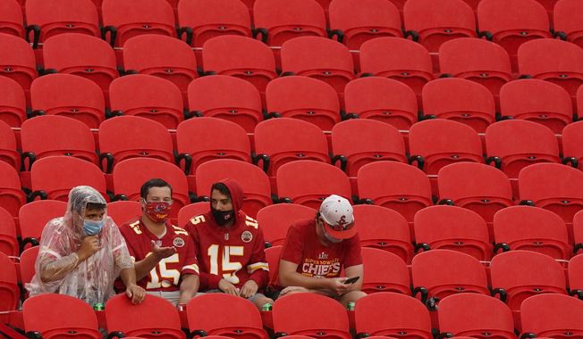Fans watch the Kansas City Chiefs during  NFL football training camp Saturday, Aug. 29, 2020, at Arrowhead Stadium in Kansas City, Mo. The Chiefs opened the stadium to 5,000 season ticket holders to watch practice as the team plans to open the regular season with a reduced capacity of approximately 22 percent of normal attendance. (AP Photo/Charlie Riedel)
