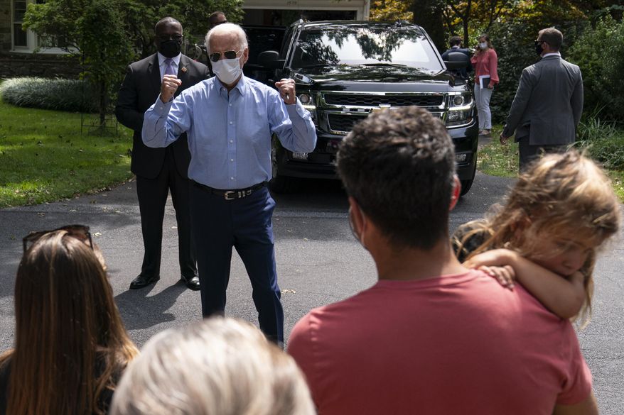 Democratic presidential candidate former Vice President Joe Biden greets people gathered as he leaves a backyard meeting in Lancaster, Pa., Monday, Sept. 7, 2020. (AP Photo/Carolyn Kaster)