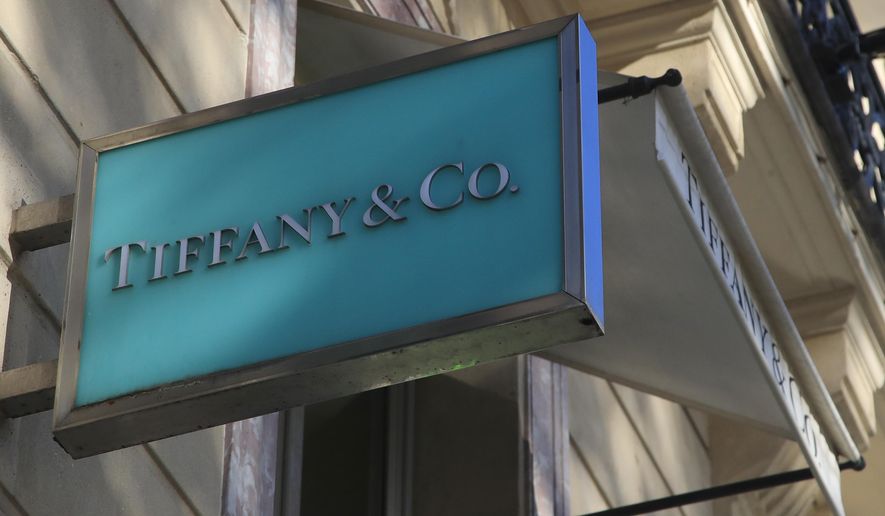 FILE - In this Nov.25, 2019 file photo, the logo of Tiffany jeweler shop is pictured on the Champs Elysees avenue in Paris. LVMH is ending its monthslong pursuit of luxury jewelry retailer Tiffany &amp;amp; Co., citing in part the impact of proposed tariffs on French goods. The Paris-based conglomerate said that it needs more time to assess the impact of U.S. tariffs on French goods and cannot close the deal before year-end. (AP Photo/Michel Euler, File)