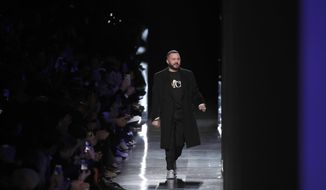 FILE -- In this Jan. 17, 2020 file photo, designer Kim Jones accepts applause after the Dior Homme Mens Fall/Winter 2020-2021 fashion collection presented in Paris. Rome fashion house Fendi announced Wednesday, Sept. 9, 2020 that Kim Jones is taking over from the late Karl Lagerfeld as creative director of haute couture, ready-to-wear and fur collections. Jones will take on the Fendi duties while staying on as artistic director of Dior Homme. (AP Photo/Francois Mori)