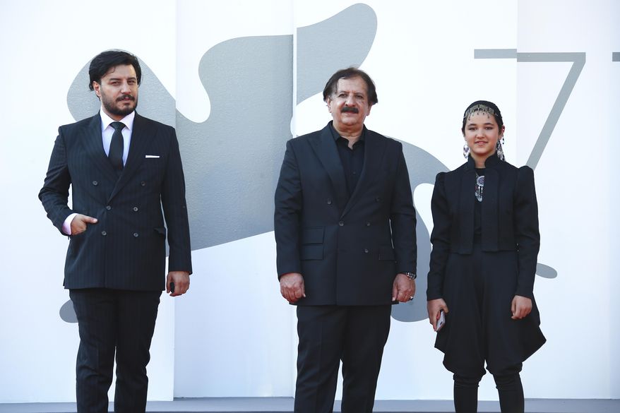 Actor Javad Ezati, from left, director Majid Majidi, and actress Shamila Shirzad pose for photographers upon arrival at the premiere of the film &#39;Khorshid (Sun Children)&#39; during the 77th edition of the Venice Film Festival in Venice, Italy, Sunday, Sept. 6, 2020. (Photo by Joel C Ryan/Invision/AP)