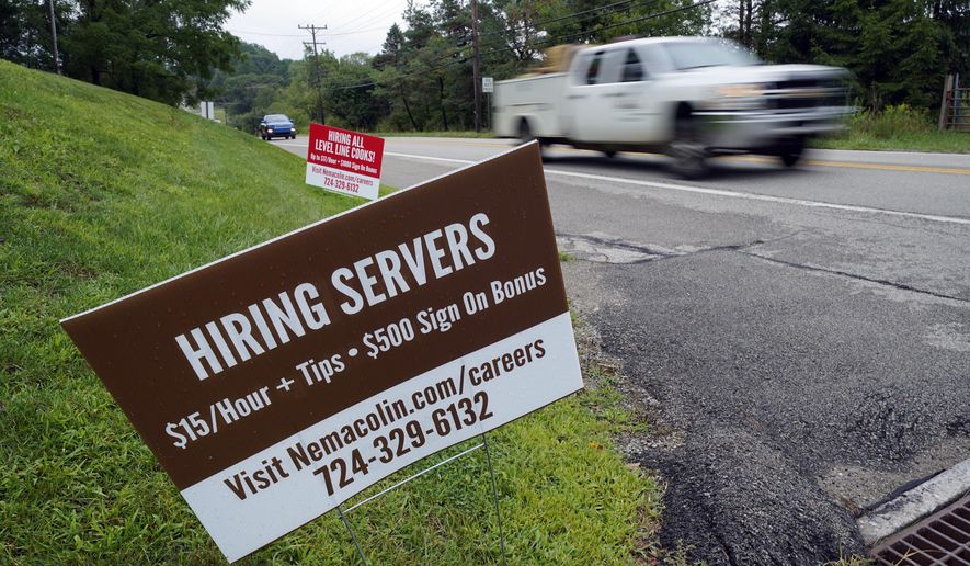 In this Wednesday, Sept. 2, 2020, file photo help wanted signs for servers and cooks at Nemacolin Woodlands Resort and Spa are displayed along route 40 at the entrance to the resort in Farmington, Pa. U.S. employers advertised more jobs but hired fewer workers in July, sending mixed signals about a job market in the wake of the coronavirus outbreak. The Labor Department said Wednesday, Sept. 9, 2020, that the number of U.S. job postings on the last day of July rose to 6.6 million from 6 million at the end of June. (AP Photo/Gene J. Puskar, File)