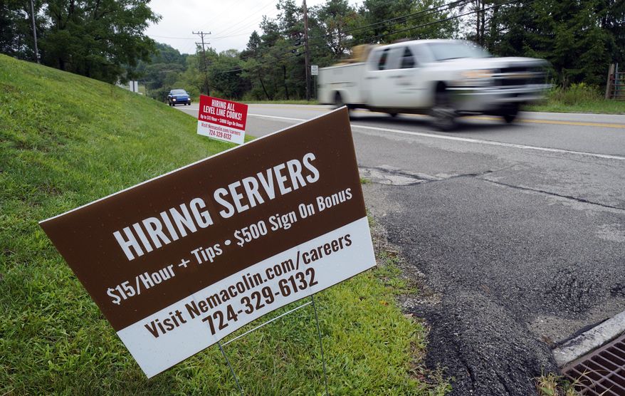 In this Wednesday, Sept. 2, 2020, file photo help wanted signs for servers and cooks at Nemacolin Woodlands Resort and Spa are displayed along route 40 at the entrance to the resort in Farmington, Pa. U.S. employers advertised more jobs but hired fewer workers in July, sending mixed signals about a job market in the wake of the coronavirus outbreak. The Labor Department said Wednesday, Sept. 9, 2020, that the number of U.S. job postings on the last day of July rose to 6.6 million from 6 million at the end of June. (AP Photo/Gene J. Puskar, File)