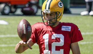 FILE - Green Bay Packers&#39; Aaron Rodgers plays with a football during NFL football practice Friday, Sept. 4, 2020, in Green Bay, Wis. Aaron Rodgers will begin his 16th season with Green Bay looking  to continue his remarkable run of success against NFC North opponents as the Packers visit Minnesota. The Packers own a 47-18-1 record in games Rodgers has played against NFC North foes, including a 6-0 mark last season. (AP Photo/Morry Gash, File)