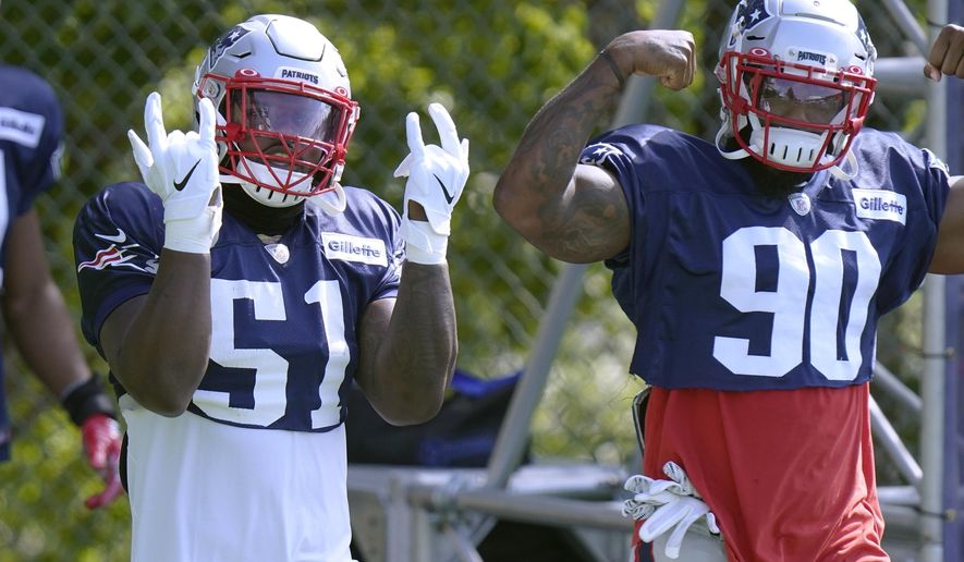 New England Patriots linebackers Ja'Whaun Bentley (51) and Shilique Calhoun (90) step onto the field for an NFL football training camp practice, Monday, Aug. 24, 2020, in Foxborough, Mass. (AP Photo/Steven Senne, Pool)