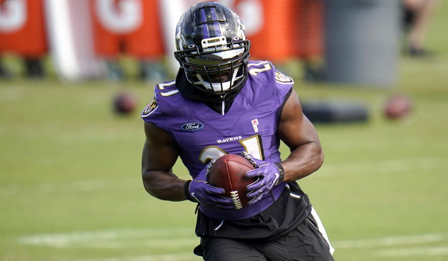 Baltimore Ravens running back Mark Ingram II works out during an NFL football training camp practice, Monday, Aug. 24, 2020, in Owings Mills, Md. (AP Photo/Julio Cortez)