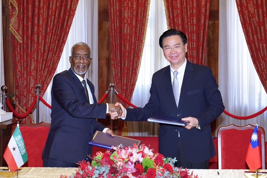 In this photo released by the Taiwan Ministry of Foreign Affairs, Taiwan's Foreign Minister Joseph Wu, right, and his counterpart from Somaliland, Yasin Hagi Mohamoud shake hands after signing an agreement for setting up representative offices in their respective territories in Taipei on Feb. 26, 2020. Taiwan has scored a rare diplomatic victory in establishing relations with the independent region of Somaliland, according to a July 1, 2020 post on the on the Taiwanese foreign ministry's website. (Taiwan Ministry of Foreign Affairs via AP)