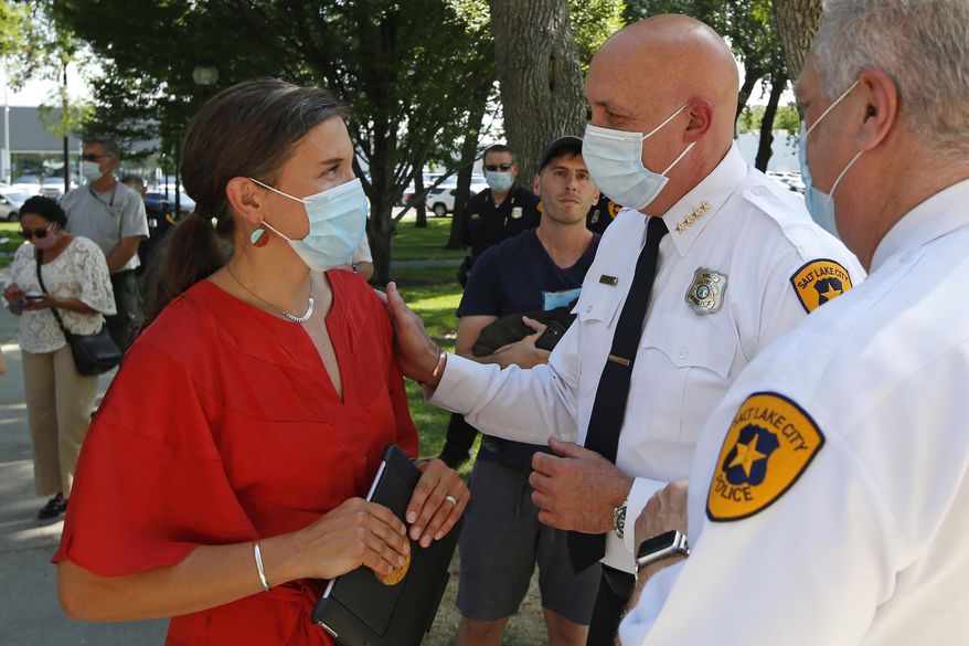 FILE - In this Aug. 3, 2020 file photo, Salt Lake City Mayor Erin Mendenhal and Salt Lake City police Chief Mike Brown speak following a news conference in Salt Lake City. The Salt Lake City Police Department vowed Tuesday, Sept. 8, 2020, to cooperate with multiple investigations of the shooting of a 13-year-old autistic boy by officers in the Salt Lake City area. The Salt Lake City Police Department said the officers were called to a home in Glendale, Utah, Friday night, Sept. 4 with a report of a boy who had threatened people with a weapon. The boy reportedly ran and was shot by an officer after being pursued by police. (AP Photo/Rick Bowmer, File)