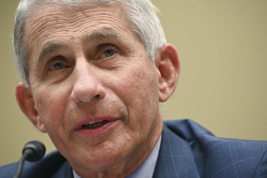 FILE - In this July, 31, 2020 file photo, Dr. Anthony Fauci, director of the National Institute for Allergy and Infectious Diseases, testifies before a House Select Subcommittee hearing on the coronavirus on Capitol Hill in Washington. Fauci says he’s sticking with his projection that a safe and effective coronavirus vaccine may be ready in early 2021. The White House adviser on the coronavirus told “CBS This Morning “hopefully we’ll be able to start vaccinations in earnest as we begin early 2021.” (Erin Scott/Pool via AP, File)