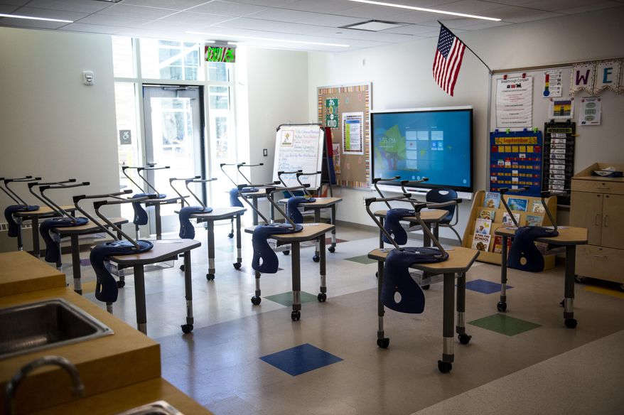 Desks are arranged in a socially-distanced manner at the newly-renovated school building for Martin Luther King Jr. Middle School and Breakthrough Magnet School-North, Friday, Sept. 4, 2020, in Hartford, Conn. (Kassi Jackson/Hartford Courant via AP)