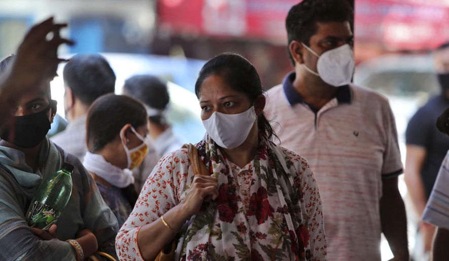 Indians wearing face masks wait for medical check-up outside a government hospital in Jammu, India, Wednesday, Sept.9, 2020. India's coronavirus cases are now the second-highest in the world and only behind the United States. (AP Photo/Channi Anand)