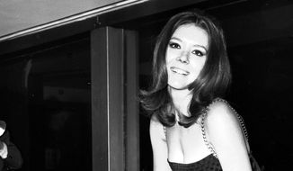 In this Nov. 8, 1967, file photo, British actress Diana Rigg poses for photographers during a press conference at the Hilton Hotel, London. Actress Diana Rigg, who became a 1960s style icon as secret agent Emma Peel in TV series The Avengers, has died at age 82. Riggs agent Simon Beresford says she died Thursday, Sept. 10, 2020, at home with her family. (AP Photo/Bob Dear, File)