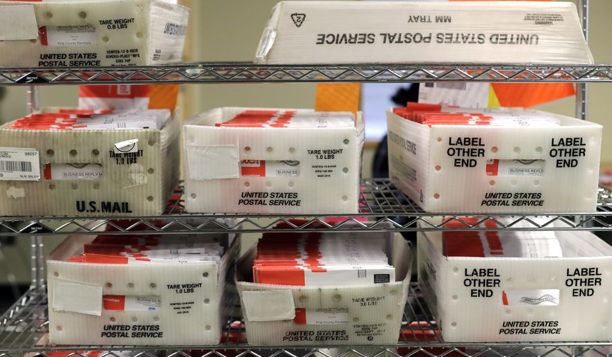 In this Aug. 5, 2020, file photo, vote-by-mail ballots are shown in U.S. Postal service sorting trays the King County Elections headquarters in Renton, Wash., south of Seattle. (AP Photo/Ted S. Warren, File)