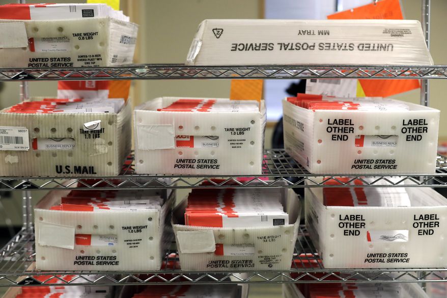 In this Aug. 5, 2020, file photo, vote-by-mail ballots are shown in U.S. Postal service sorting trays the King County Elections headquarters in Renton, Wash., south of Seattle. (AP Photo/Ted S. Warren, File)