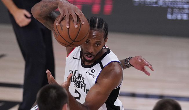 Los Angeles Clippers&#x27; Kawhi Leonard (2) grabs a loose ball during the first half of an NBA conference semifinal playoff basketball game against the Denver Nuggets, Wednesday, Sept. 9, 2020, in Lake Buena Vista, Fla. (AP Photo/Mark J. Terrill)