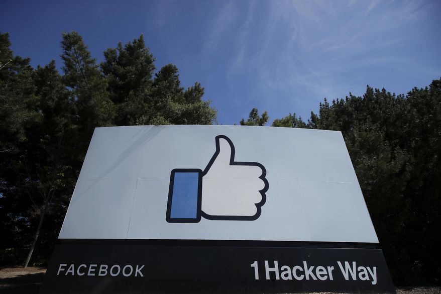 FILE - In this April 14, 2020 file photo, the thumbs up Like logo is shown on a sign at Facebook headquarters in Menlo Park, Calif. Facebook may be forced to stop sending data about its European users to the U.S., in the first major fallout from a recent court ruling that found some trans-Atlantic data transfers don't protect users from American government snooping. The social network said Wednesday, Sept. 9, 2020 that Ireland's Data Protection Commission has started an inquiry into how Facebook shifts data from the European Union to the United States. (AP Photo/Jeff Chiu, File)