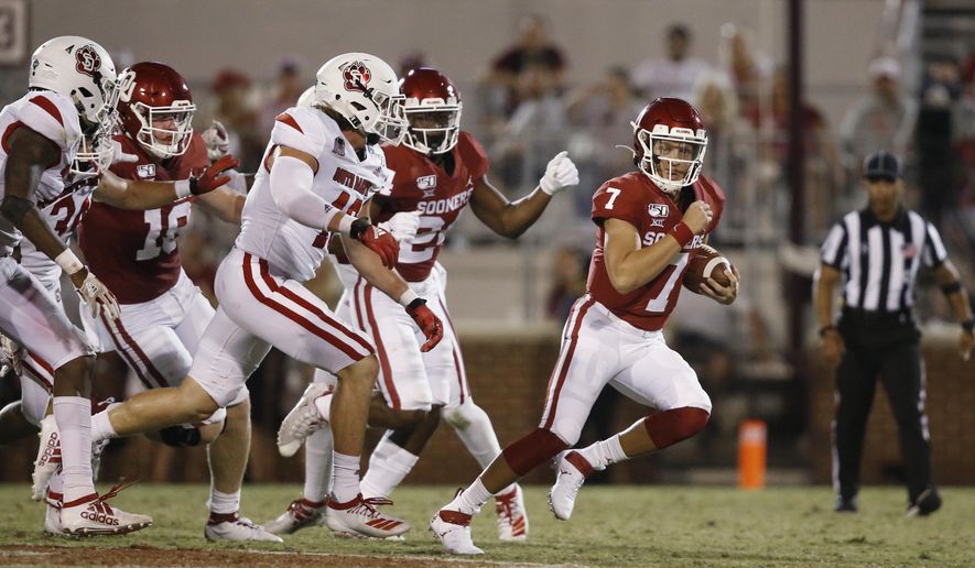 FILE - In this Sept. 7, 2019 file photo, Oklahoma quarterback Spencer Rattler (7) carries in the fourth quarter of an NCAA college football game against South Dakota, in Norman, Okla. The coronavirus pandemic has shut down much of Division I football, but with three of the Power Five leagues still playing, there are still some big games to look forward to. Oklahoma takes on Texas on Oct. 10, 2020. (AP Photo/Sue Ogrocki, File)