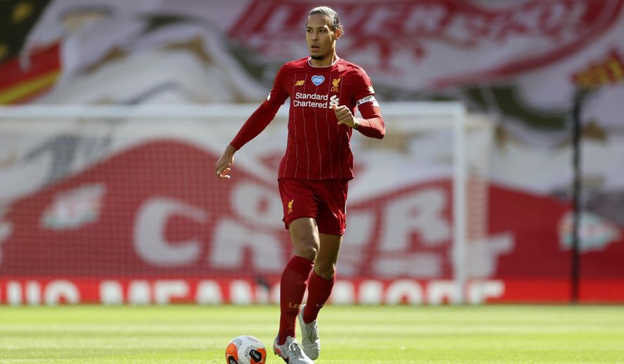 FILE - In this Sunday, July 5, 2020 file photo, Liverpool&#39;s Virgil van Dijk runs with the ball during theie English Premier League soccer match against Aston Villa at Anfield Stadium in Liverpool, England. Liverpool ended a 30-year wait for a league title in style last season as Jurgen Klopp’s men lost only three times en route to lifting the trophy last month - retaining the crown is often a more difficult proposition, however, and the Reds will have to remain at their best if they are to do so. (Carl Recine/Pool via AP, file)