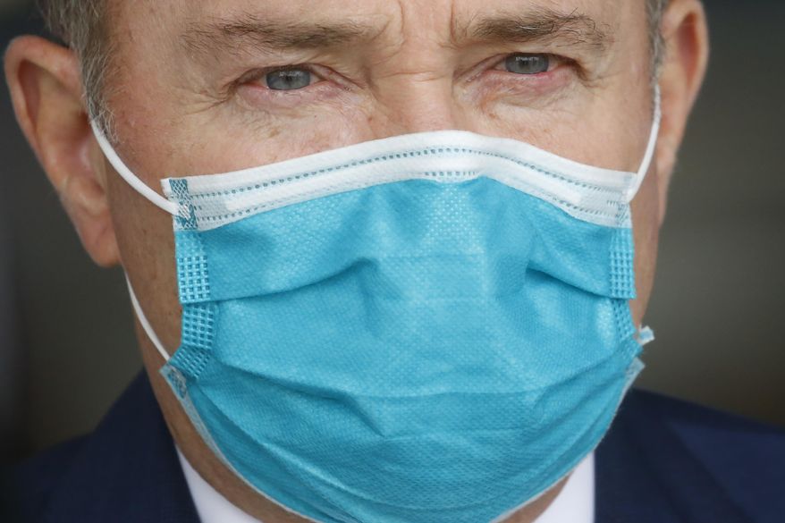 FILE - Utah Gov. Gary Herbert wears a mask during a news conference on April 15, 2020, in Salt Lake City. Utah has set new goals for fighting the coronavirus pandemic that include keeping the state's fatality rate below 1% and maintaining an unemployment rate below 4.5%, state leaders said. Gov. Gary Herbert and other state leaders rolled out their new plan, which prioritizes both public health and boosting the state's economy through the fall and winter. (AP Photo/Rick Bowmer, File)
